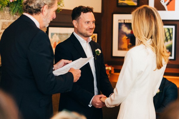 bride groom and celebrant at alter setting wedding