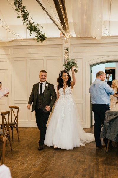 bride and groom enter ballroom