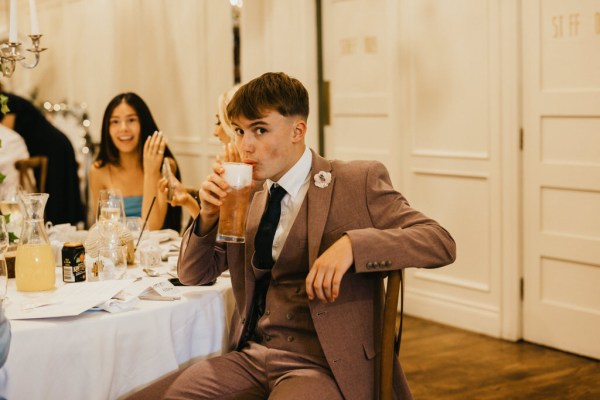 Man takes a sip of beer from pint