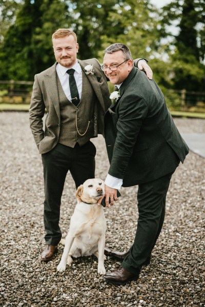 groom father and Labrador dog outside house