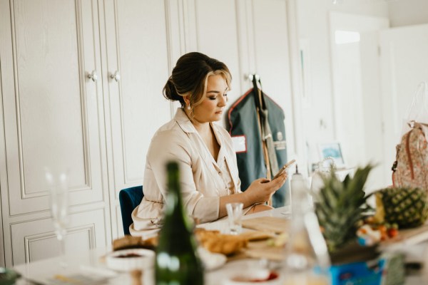 bridesmaids texting on phone as she gets ready