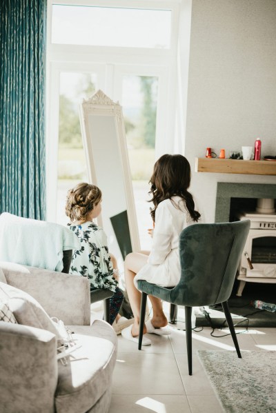 bride sits and looks at reflection in mirror