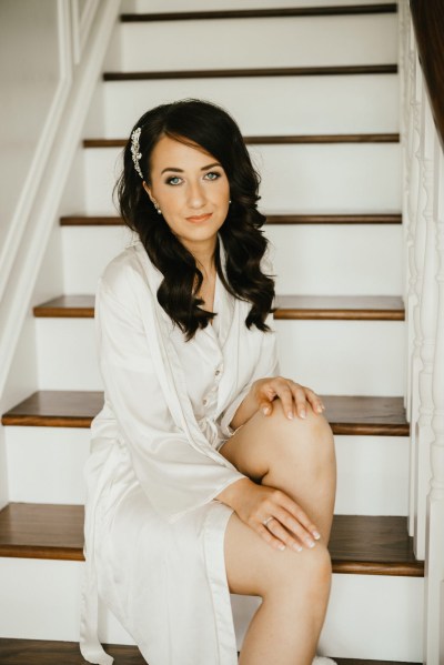 bride sits on the stairs to house