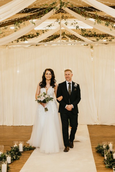 father of the bride walks his daughter down the aisle