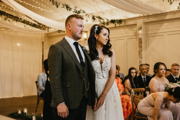 bride and groom in front of guests during ceremony