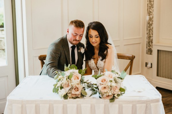 bride and groom sign marriage certificate