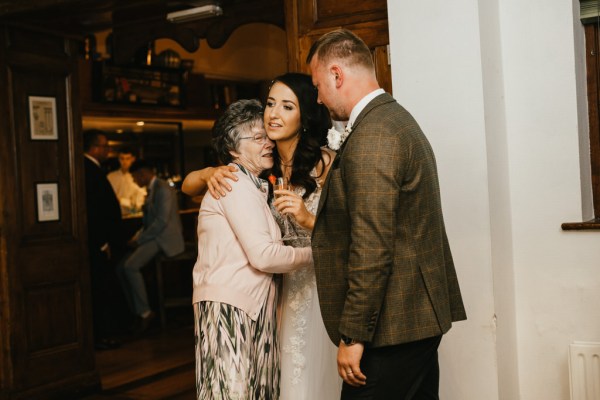 bride groom and grandmother hug