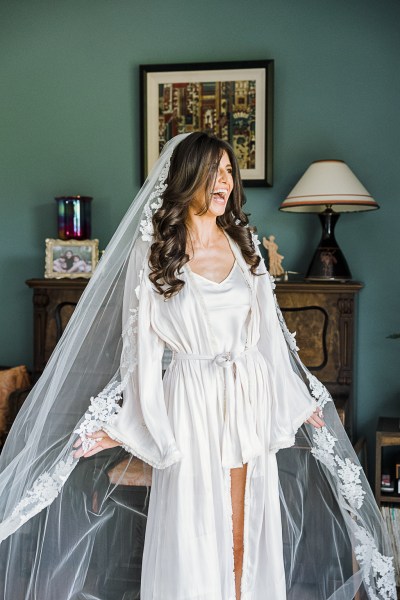 bride is getting ready and wearing her bridal veil