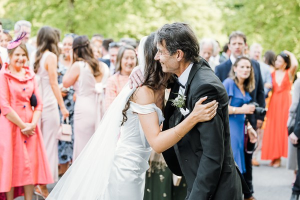 father and bride hug