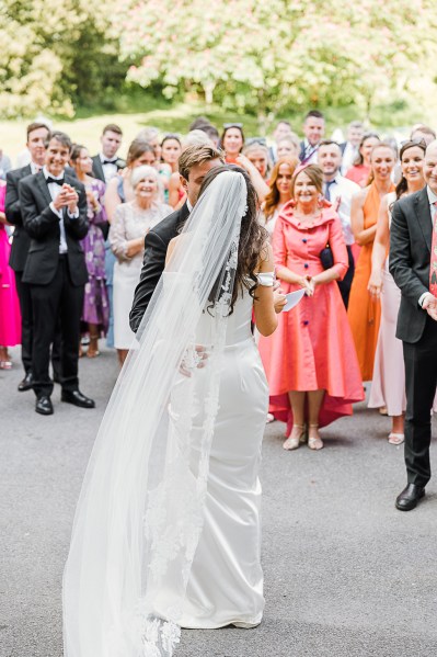 bride is greeted by family members outside church