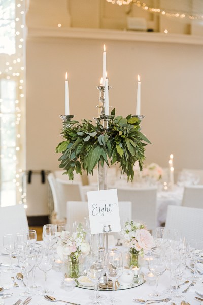 table setting glasses cutlery candles and flowers