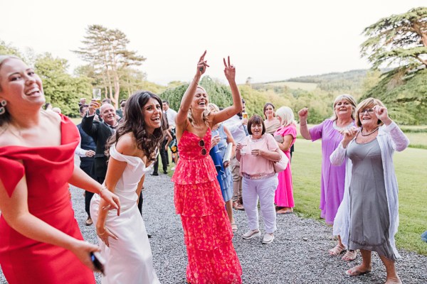 Colourful dressed women celebrate with the bride