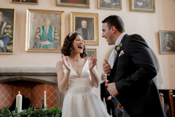 bride and groom clapping singing along to wedding band