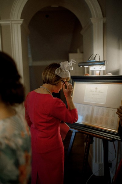 woman in red looking at seating arrangement details