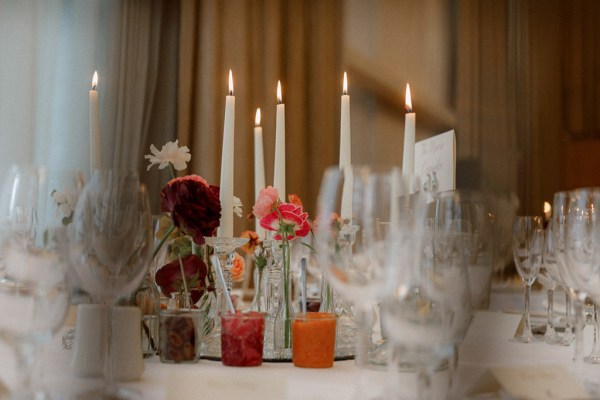 table setting orange candles long white candles lit