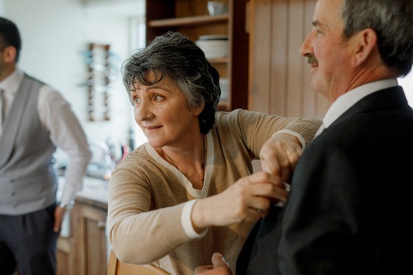 mother helps husband get ready