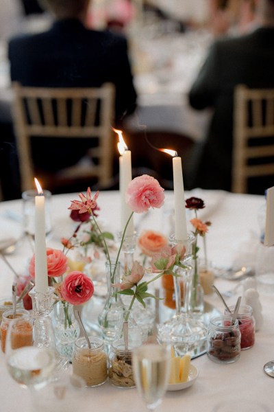 candles lit on table colourful flowers