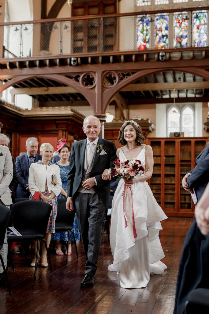 father of the bride walks his daughter down the aisle