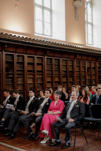 shot of guests seated during wedding ceremony church setting