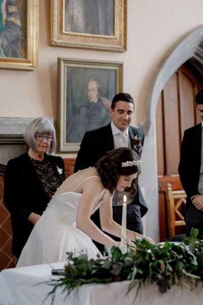 bride signs marriage certificate with groom