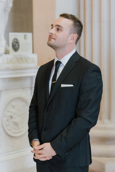 groom stands nervously waiting for the bride