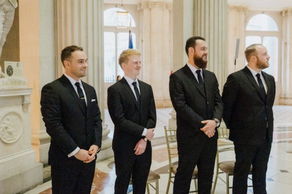 groom and groomsmen await the bride