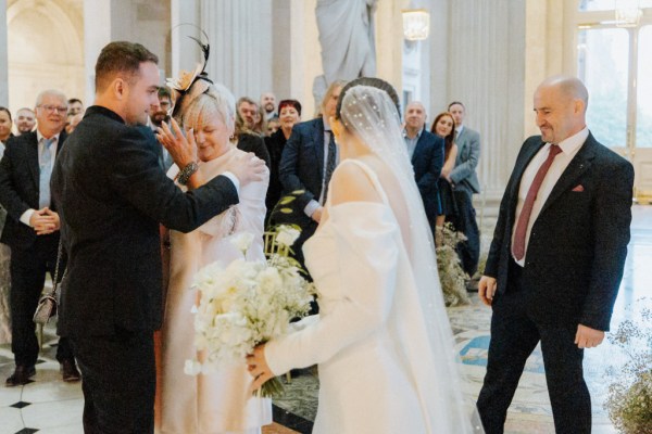 emotional mother and groom son hug