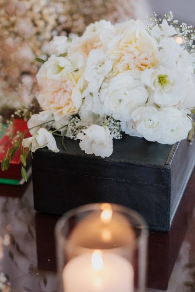 white rose flowers on top of lantern candle lit inside