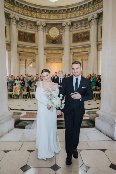 bride and groom exit ceremony room setting smiling