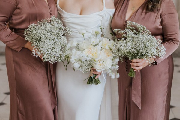 bride in the middle of her bridesmaids the focus is on the bouquets