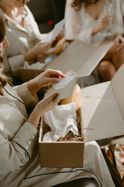 bridesmaids open gifts from bride