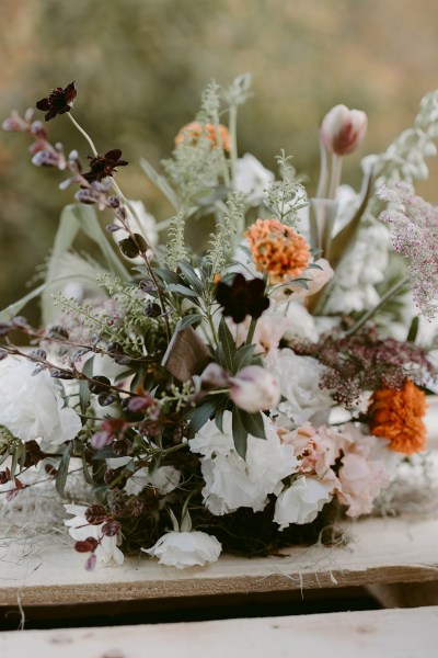 bouquet containing orange and white flowers roses