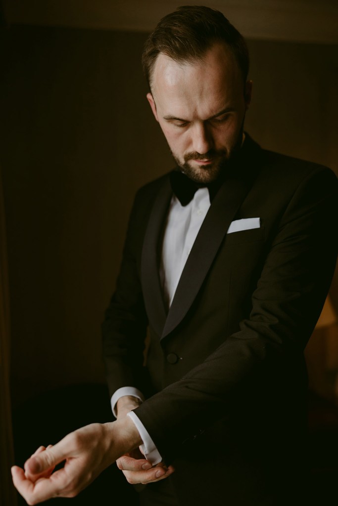 groom looks down as he gets ready