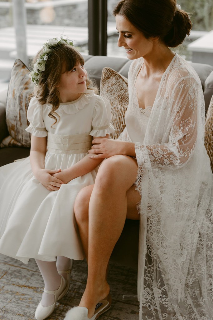 mother and daughter little girl both wearing white bride