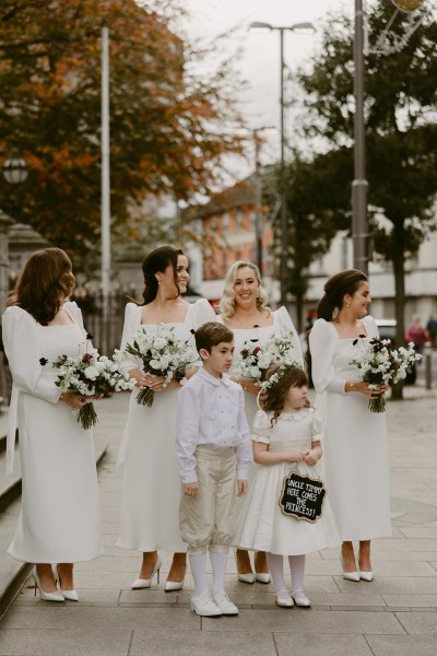 little boy girl bridesmaids and bride all wearing white