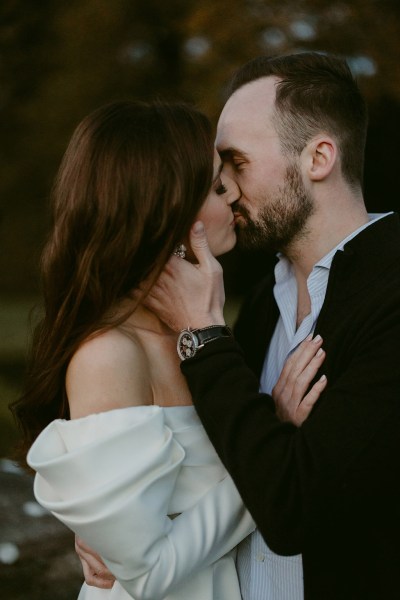 bride and groom go in for a kiss