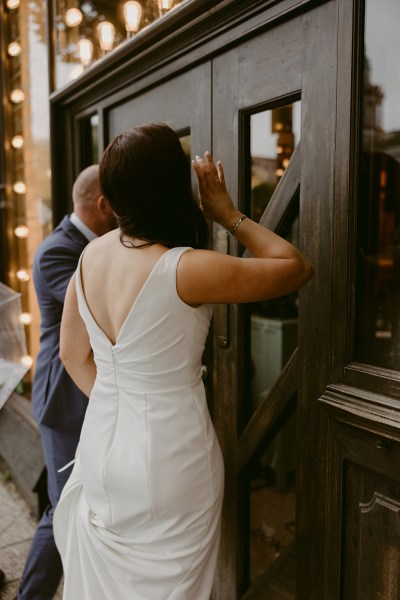 bride and groom enjoy a drink together