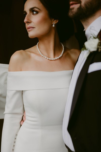 bride turns her face away from groom over the shoulder dress and suit detail