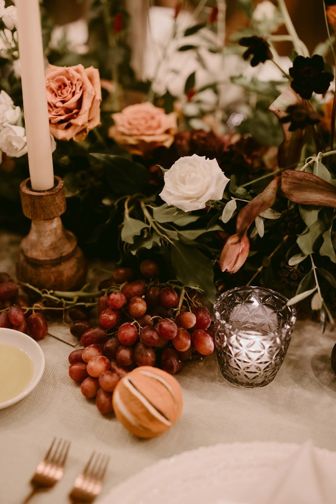 White rose red berries grapes glasses and orange flowers