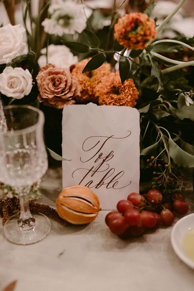 top table red berries grapes glasses and orange flowers