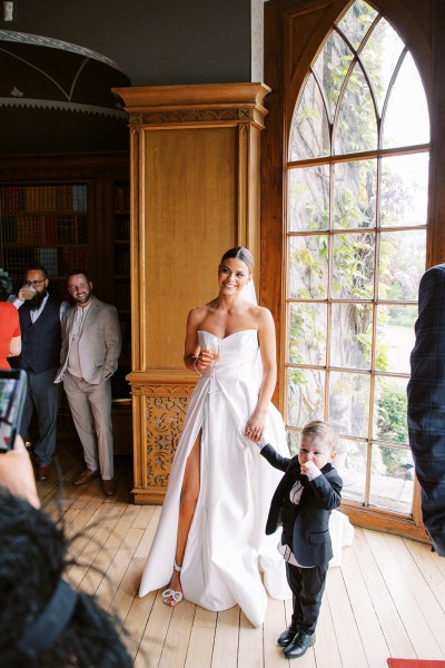 mother and son bride little boy wearing suit they hold hands