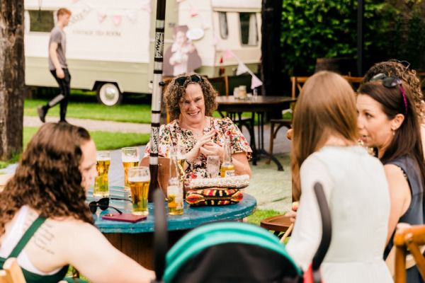 woman sits at table chatting