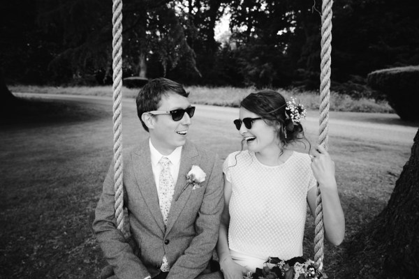 black and white bride and groom on the swing outside in garden