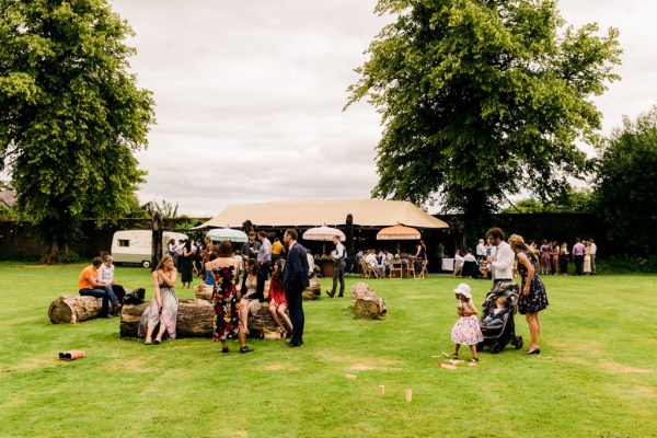 guests seated on the grass hut in background speeches