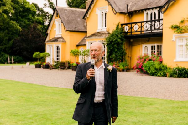 father/man in suit gives speech