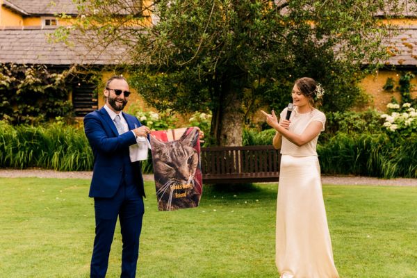 bride and groom clapping in garden on grass