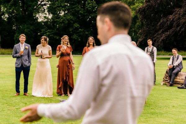 man in suit guests standing on grass