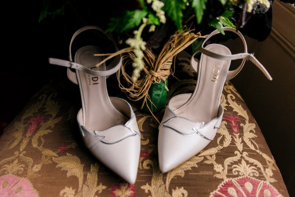 heels and flowers placed on ground/carpet