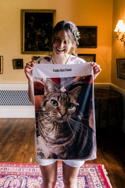 bridesmaid holds up cat patterned material clothing item