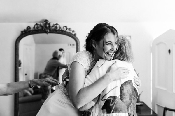 bride goes in to hug mother